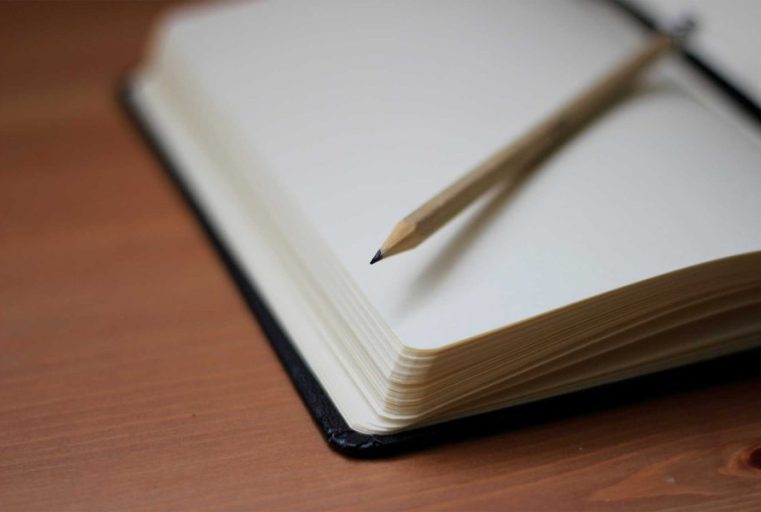 Notebook with pencil on top for writing counselling notes